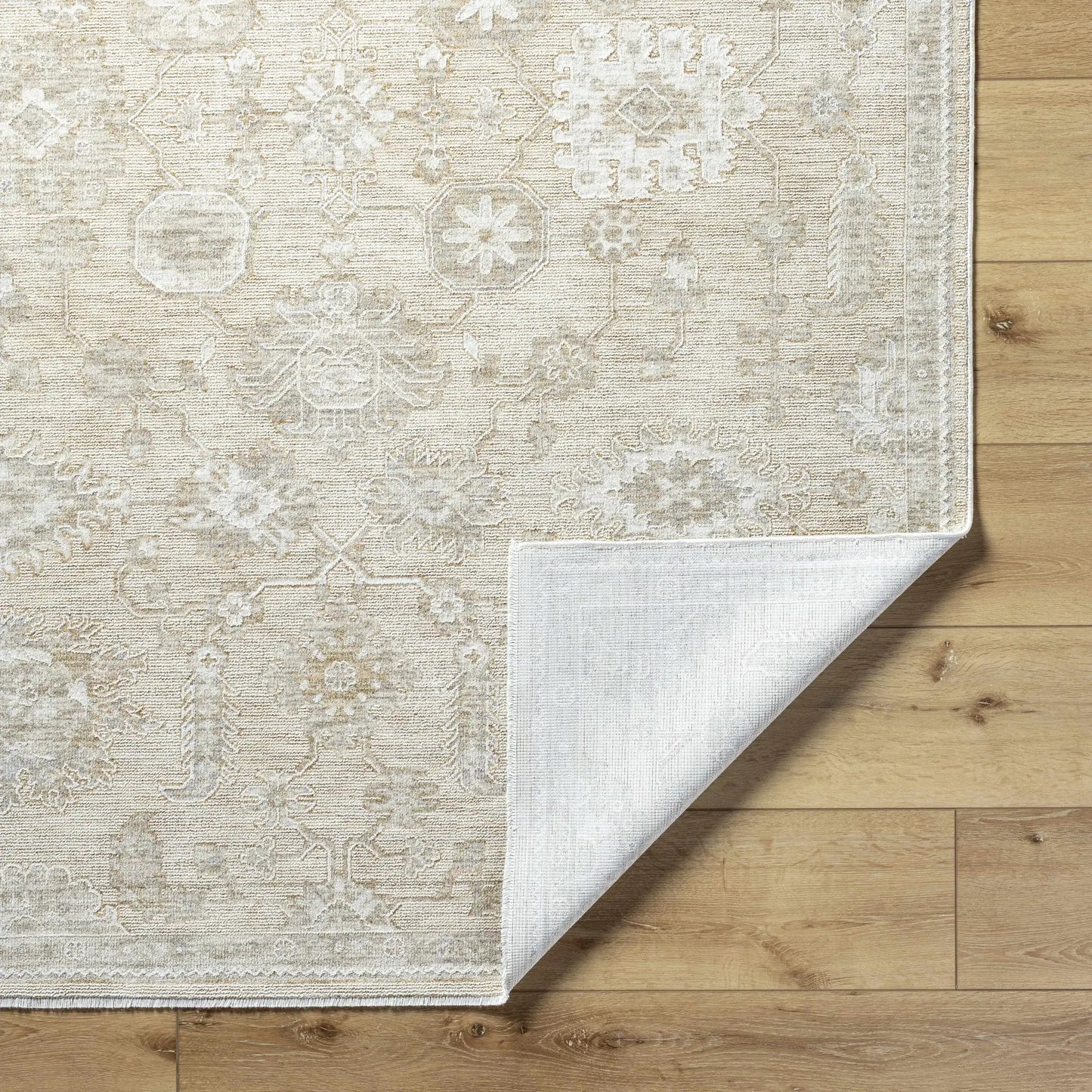Yonca Luxe Rug by Boutique Rugs, beige patterned clearance rug on wood floor on Tampa Home & Garden Store