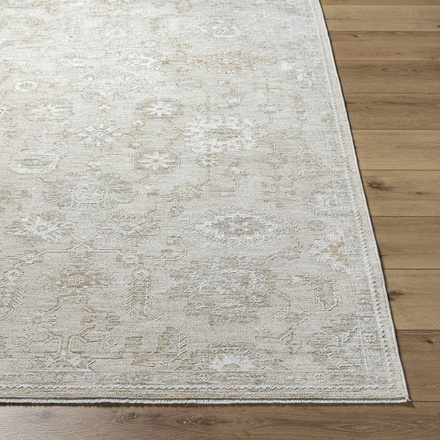 Yonca Luxe Rug cream beige distressed pattern area rug on wooden floor on Tampa Home & Garden Store