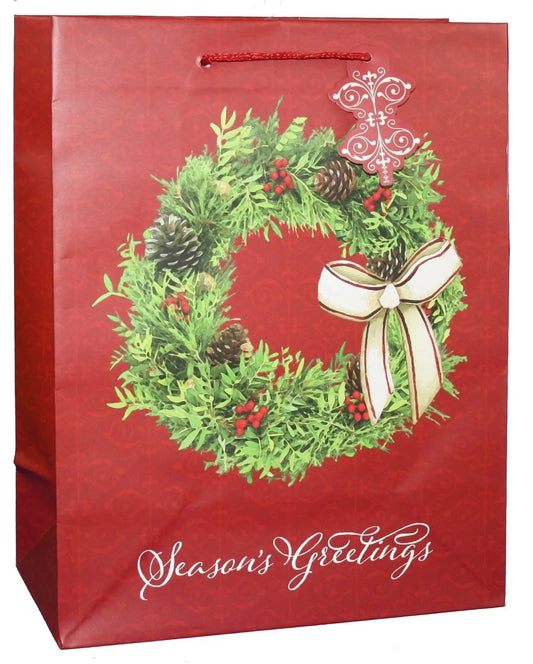 Gift bag featuring a large red wreath design with greenery, pinecones and bow on Tampa Home & Garden Store