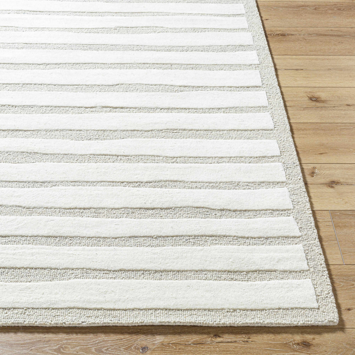 Zerah Area Rug by Boutique Rugs, beige and white striped rug on wood floor on Tampa Home & Garden Store