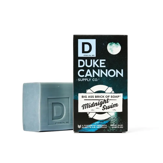Duke Cannon Midnight Swim soap brick with a blue soap block beside the dark Duke Cannon box on Tampa Home & Garden Store