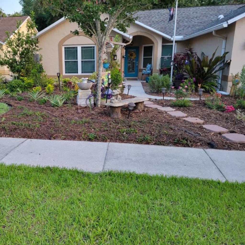 organic brown mulch spread on landscape beds save money and water.