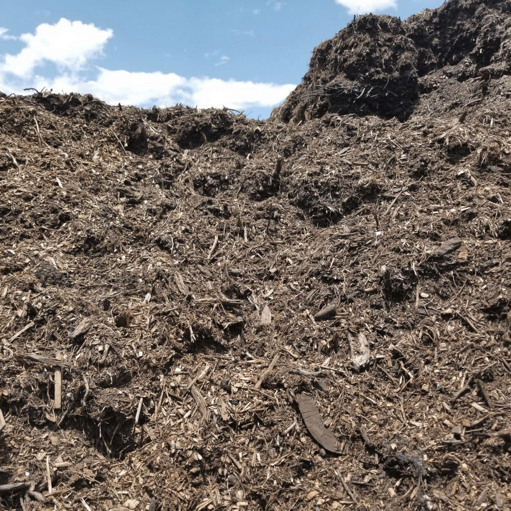 Bulk pile of brown mulch to load truckloads of mulch for free delivery.