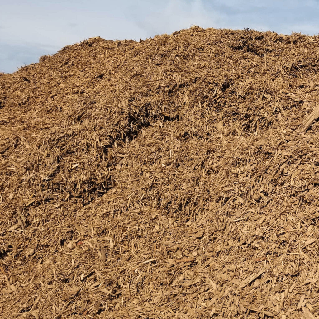 Natural light color pile of mulch near me delivered.